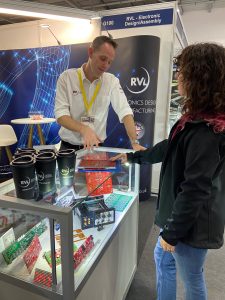 Peter Hall, new R&D Director at RVL, discusses electronics design with Andreea at the Southern Manufacturing & Electronics Show in Farnborough, Surrey in February 2024.